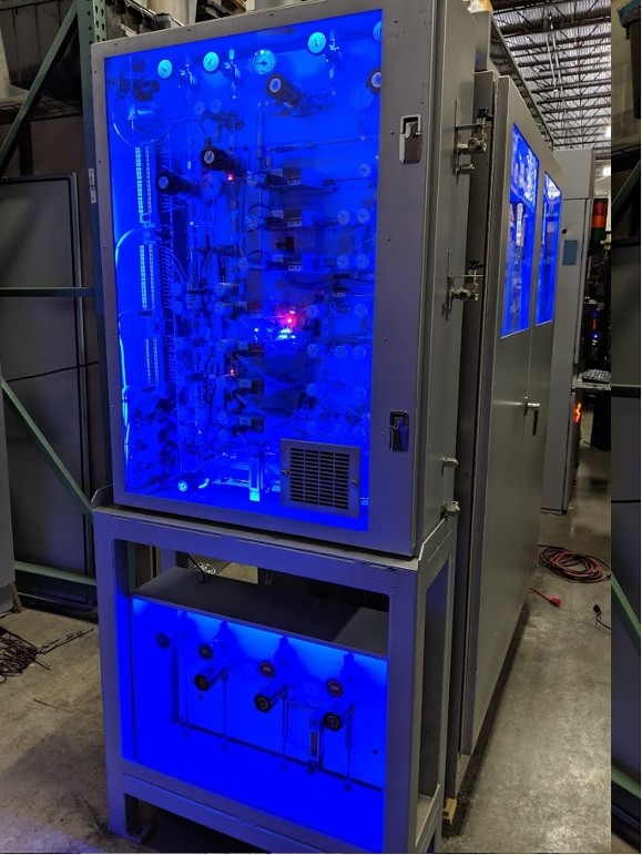 Large industrial cabinet with stainless steel piping and ultraviolet lighting